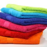 colorful stacked bathroom towels on a white background